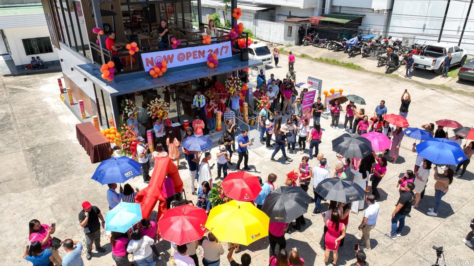 Guests and mascots at the Dunkin’ Drive-Thru grand opening