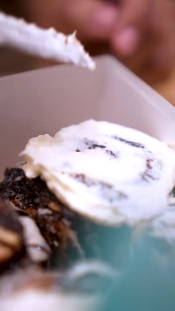 Cream cheese frosting on a Cinnabon roll